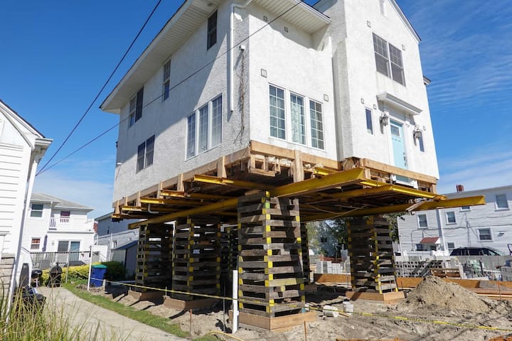 A team of professionals using specialized equipment to raise a house in Frederick, preparing it for elevation and renovation